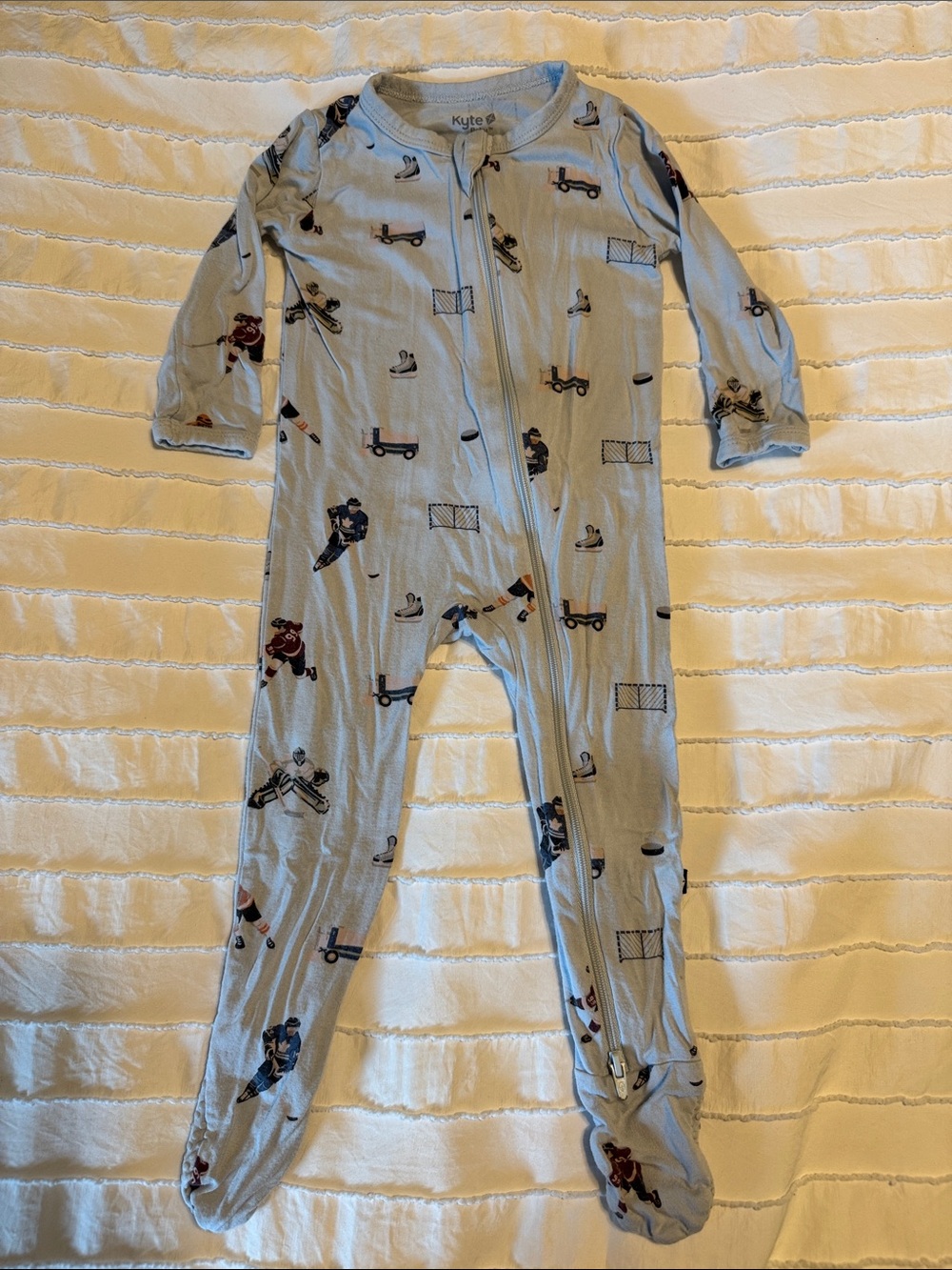 Kyte BABY 6-12 mo Light Blue Hockey & Skate Print Footed One-Piece